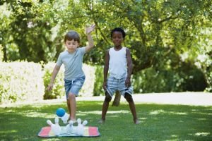 Children playing outdoor bowling game