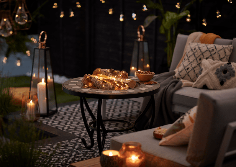 Outdoor fairy lights, cushions and throws