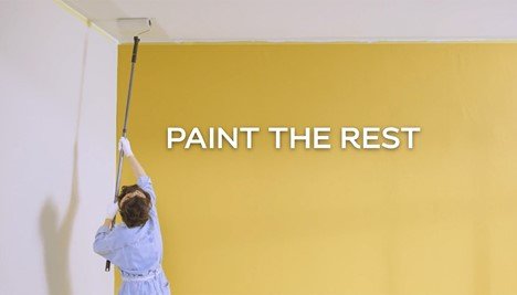 woman painting a ceiling with a roller