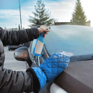 image of man de-icing a car with de-icer spray 