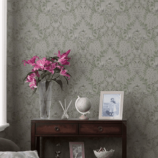 an image of green floral wallpaper and a side table with flowers and a photo frame on the top 