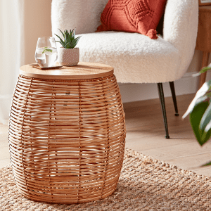 an image of a rattan side table with a small potted plant on the top