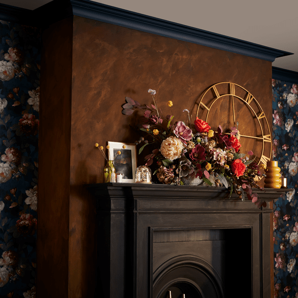 an image of a brown feature wall with a brown mantelpiece and gold wall clock 