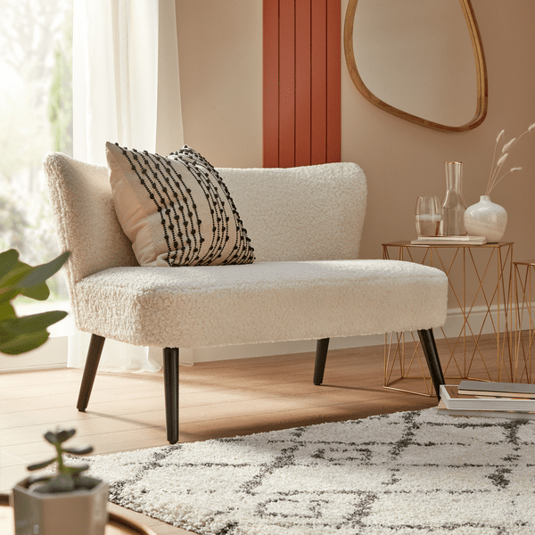 an image of a white open arm sofa on a rug 