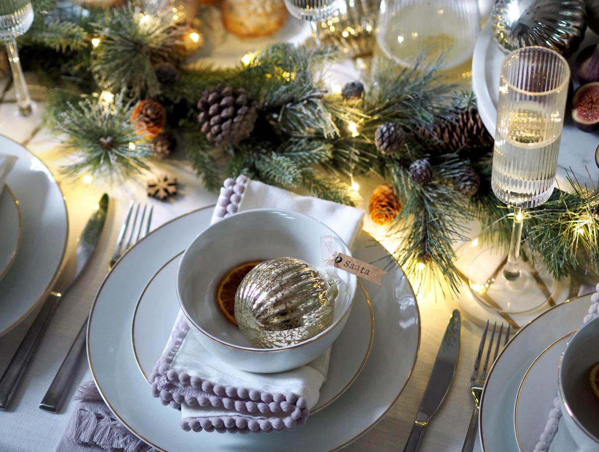 A table setting feature Christmas decorations and a Santa name tag
