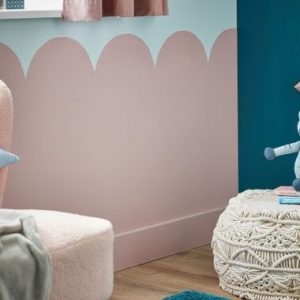 Photograph of pink scalloped-shape paint design on a bedroom wall