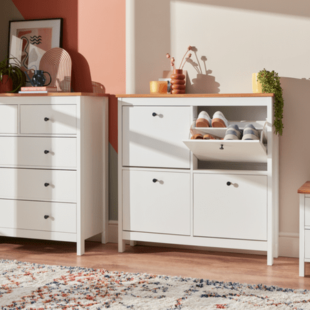 White square cabinet with 4 doors. One is open showing shoes in shoe rack inside.
