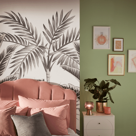 White wall paper with a palm tree on next to a painted green wall.
