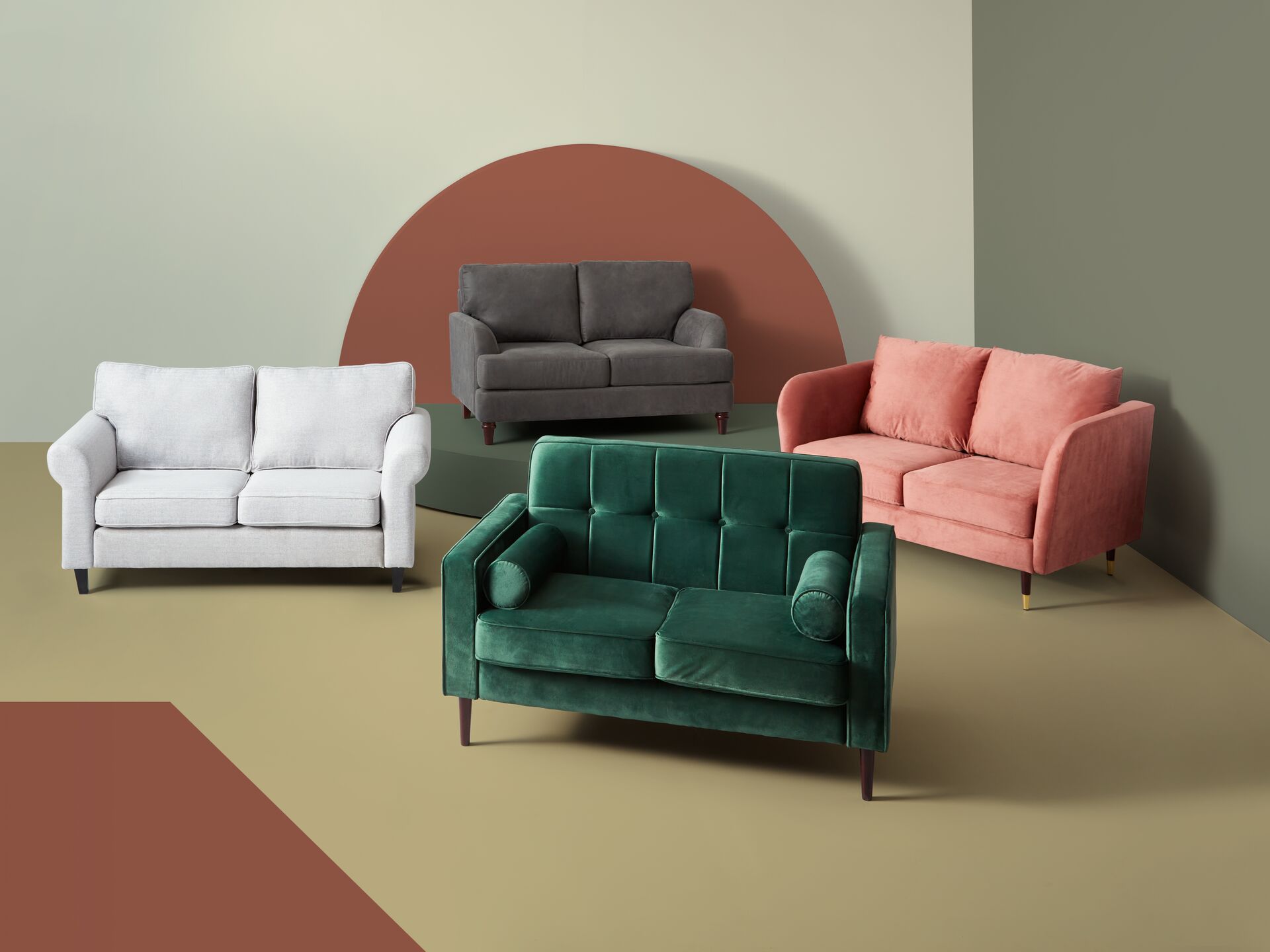 photograph of four sofas in the colours pink, green, grey and white