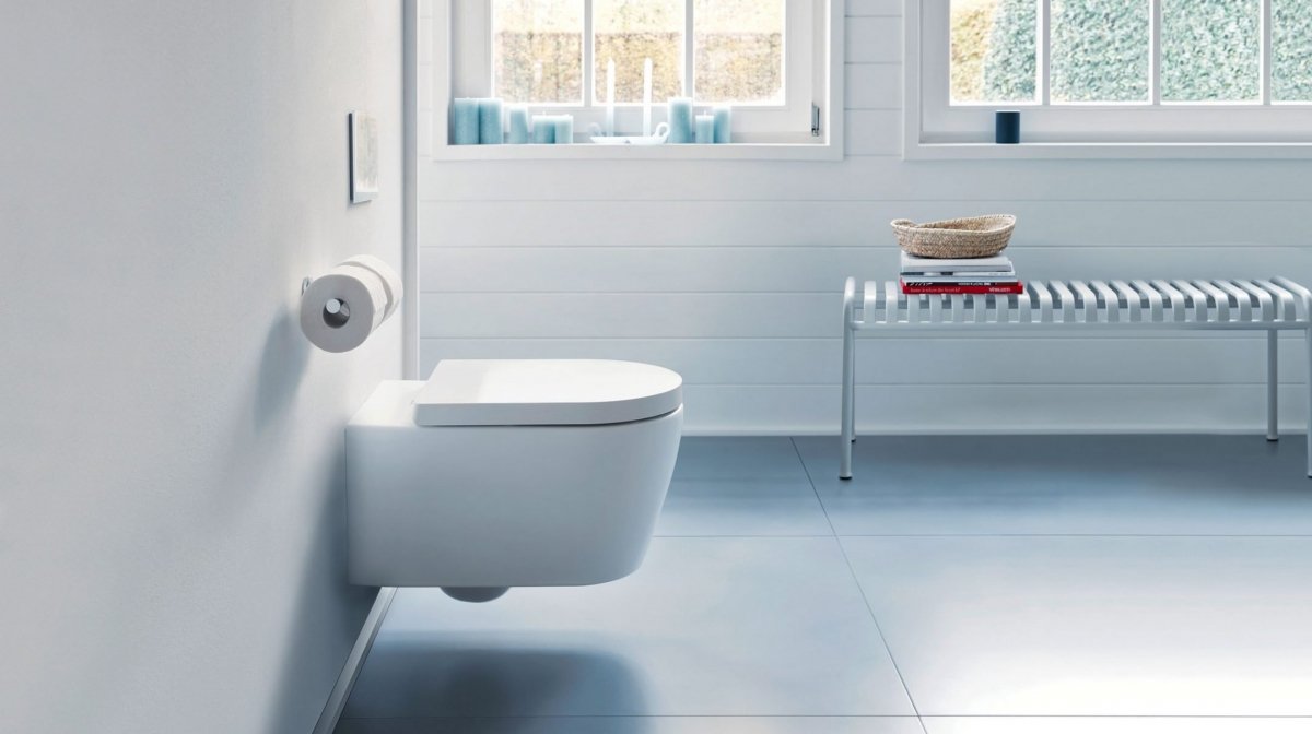 Photograph of a white wall-hung toilet in a tiled modern bathroom