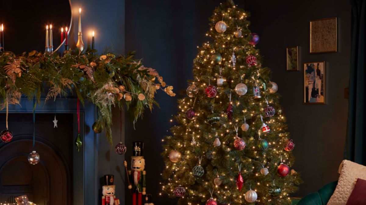 Decorated Christmas tree and fireplace adorned with foliage