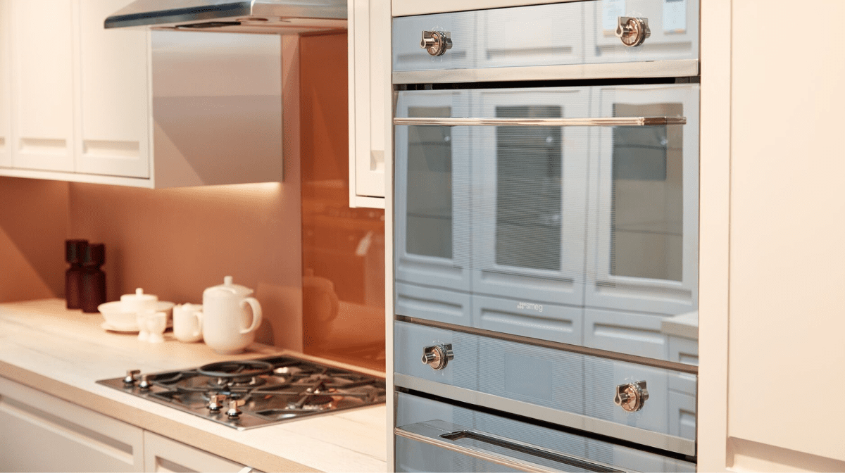 Photograph of a navy blue oven in a modern cream kitchen