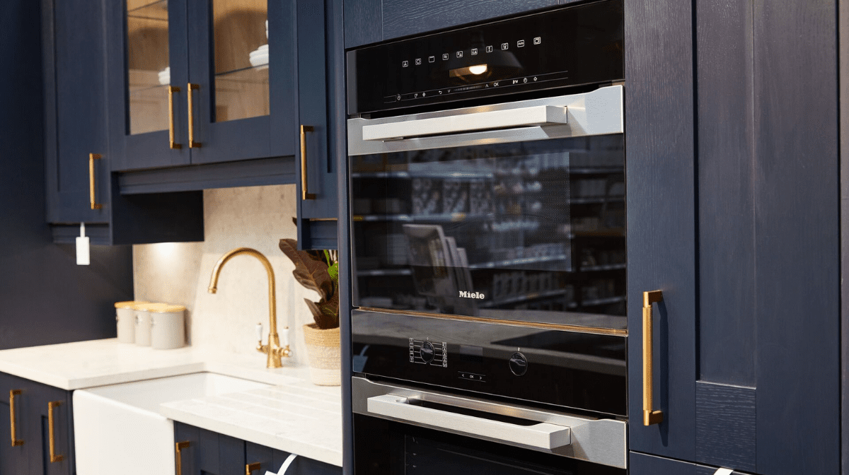 Photograph of modern oven in a navy blue kitchen