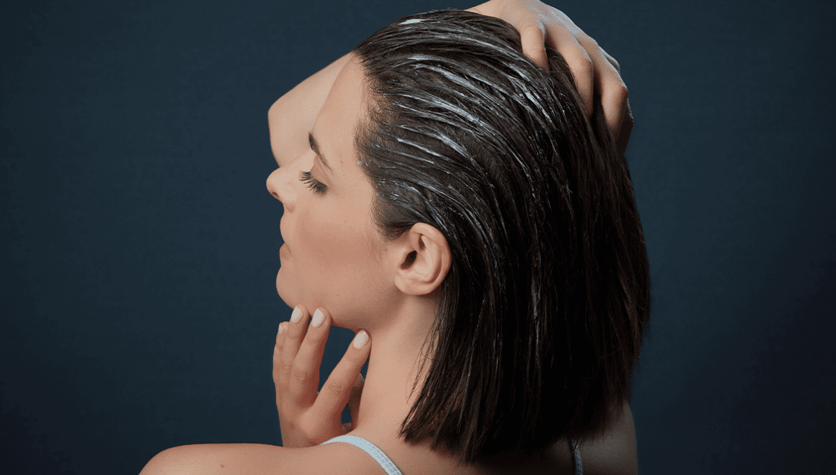 woman giving herself a scalp massage