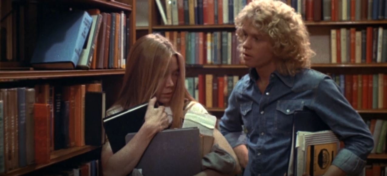 Carrie (Sissy Spacek) and Tommy (William Katt) talk in a library in Carrie (1976)