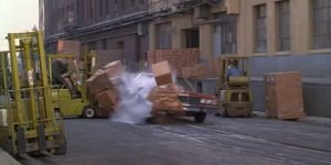 A car drives through cardboard boxes in To Live and Die in L.A. (1985)
