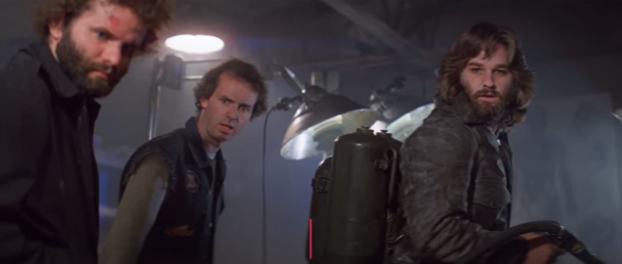 The crew look on at something surprising in The Thing (1982)