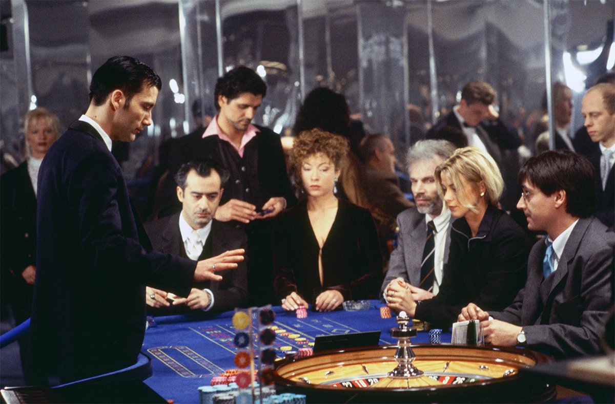 Players gather around a roulette table in Croupier (1998)