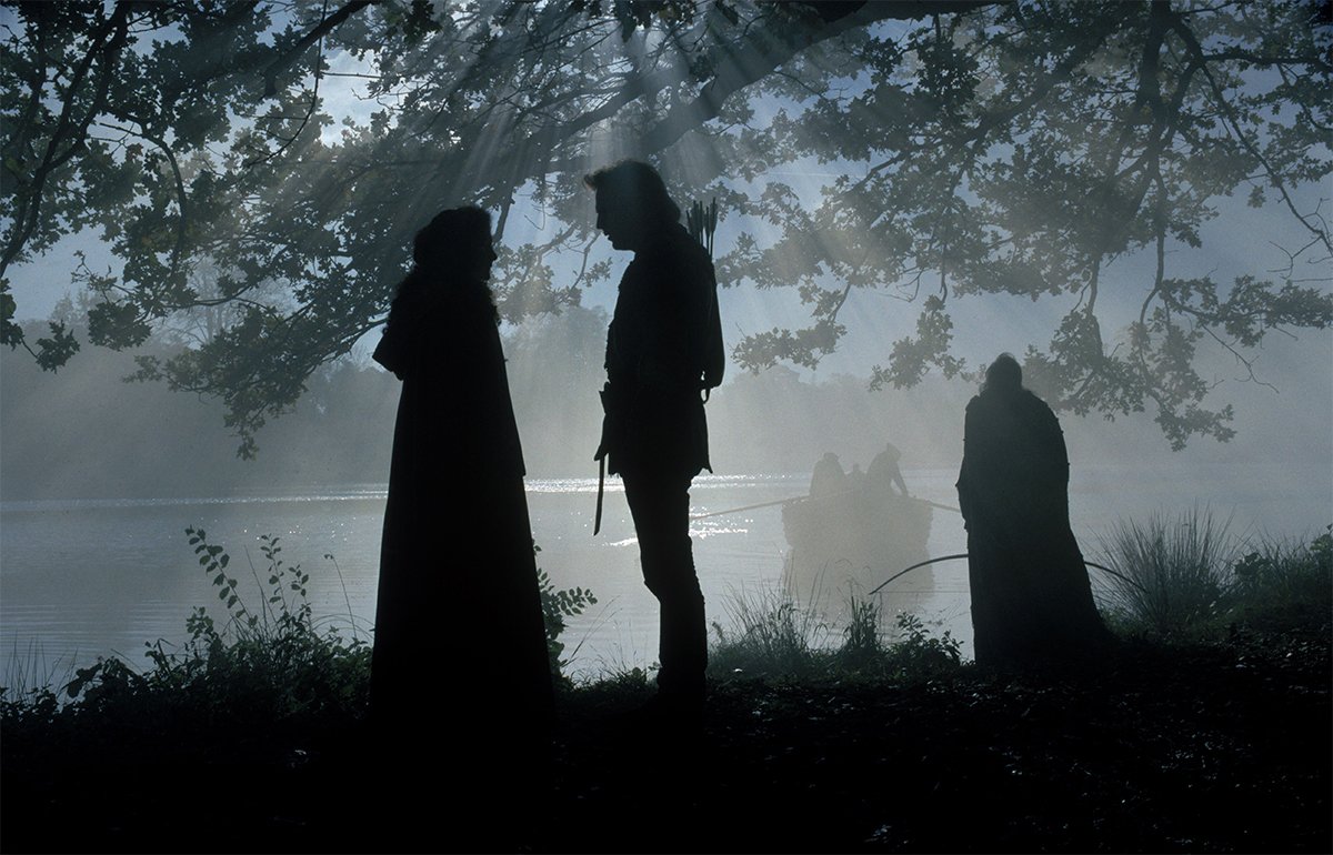 Robin and Marian in conversation by a river in Robin Hood: Prince of Thieves (1991)