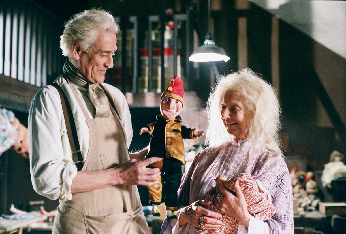 An elderly couple admire their puppet in Dolls (1987)