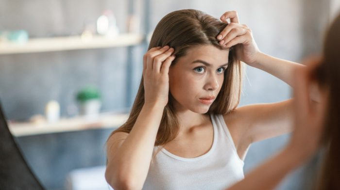 Girl checking her dry scalp