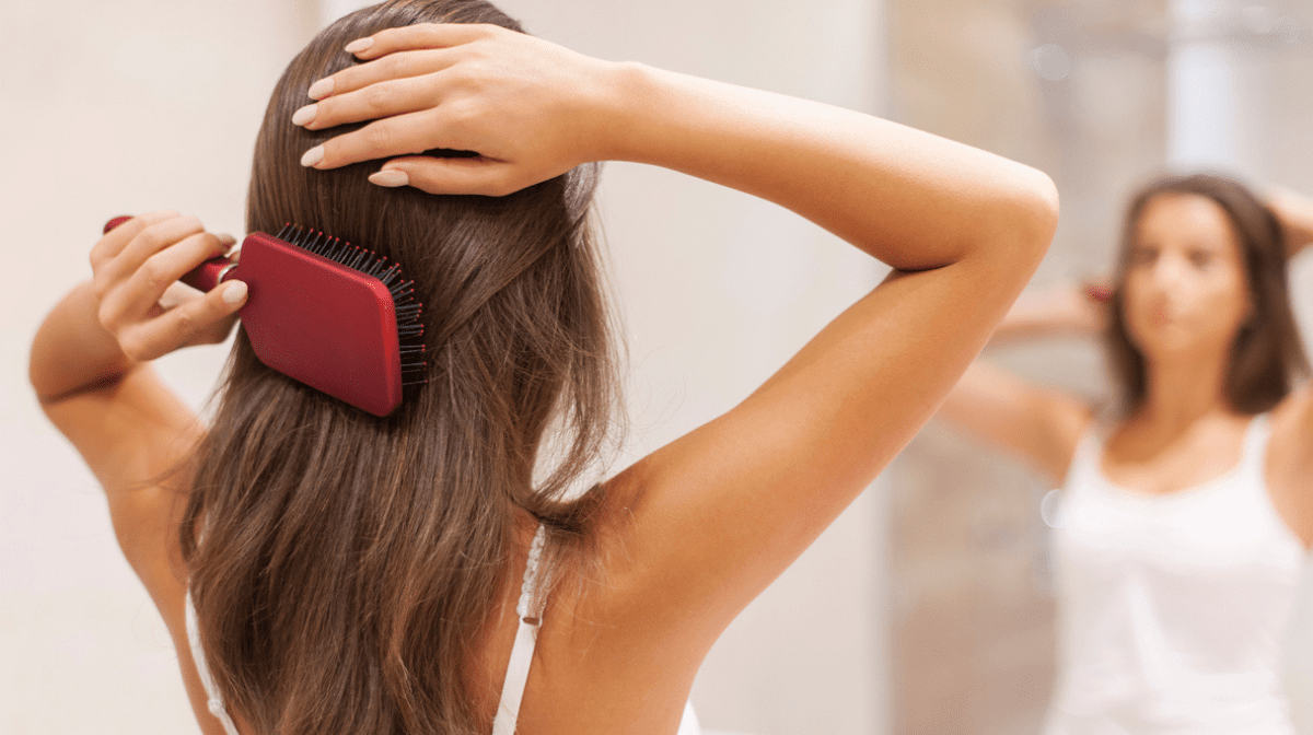 woman brushing healthy hair