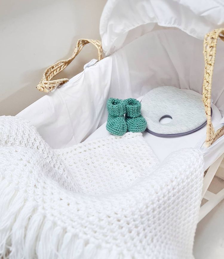 A baby bassinet with crochet boots
