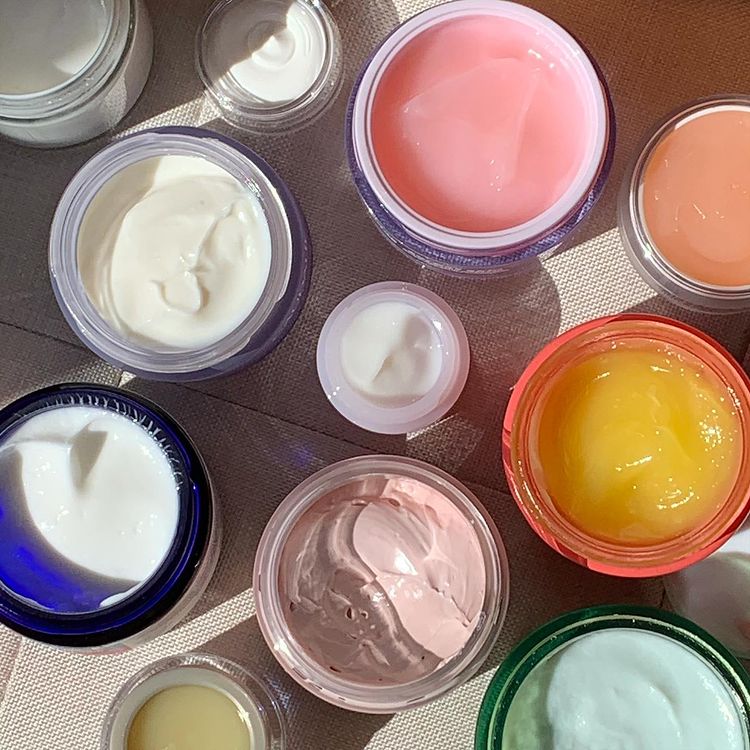 A lot of pots of facial creams open