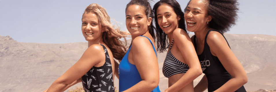 A row of women wearing Speedo swimsuits