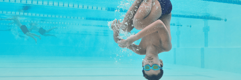 A boy wearing Speedo goggles in a swimming pool