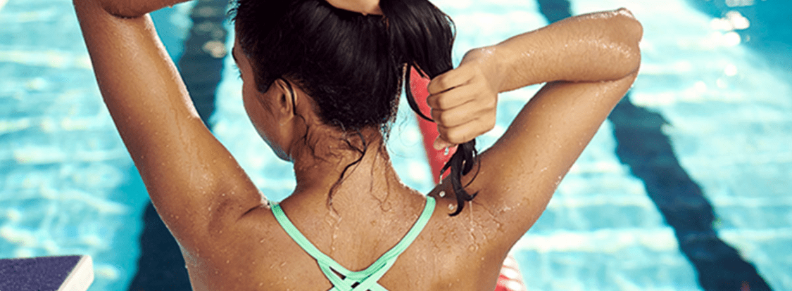 A woman draining her hair after swimming