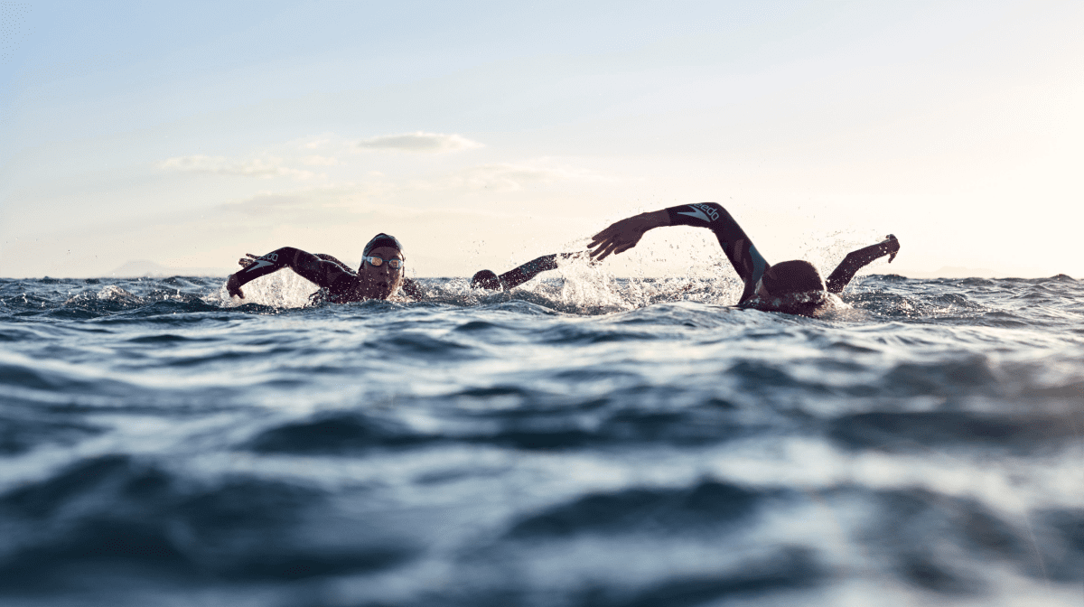 Two swimmers completing triathlon training in open water