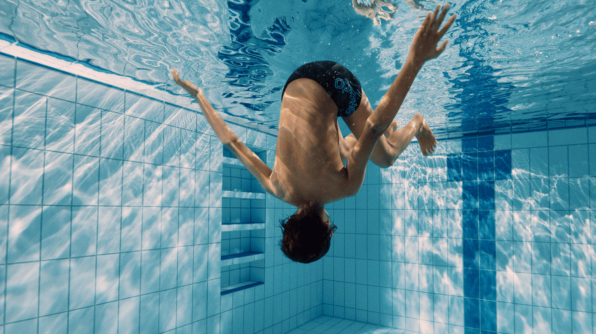 A boy wearing Speedo goggles in a swimming pool