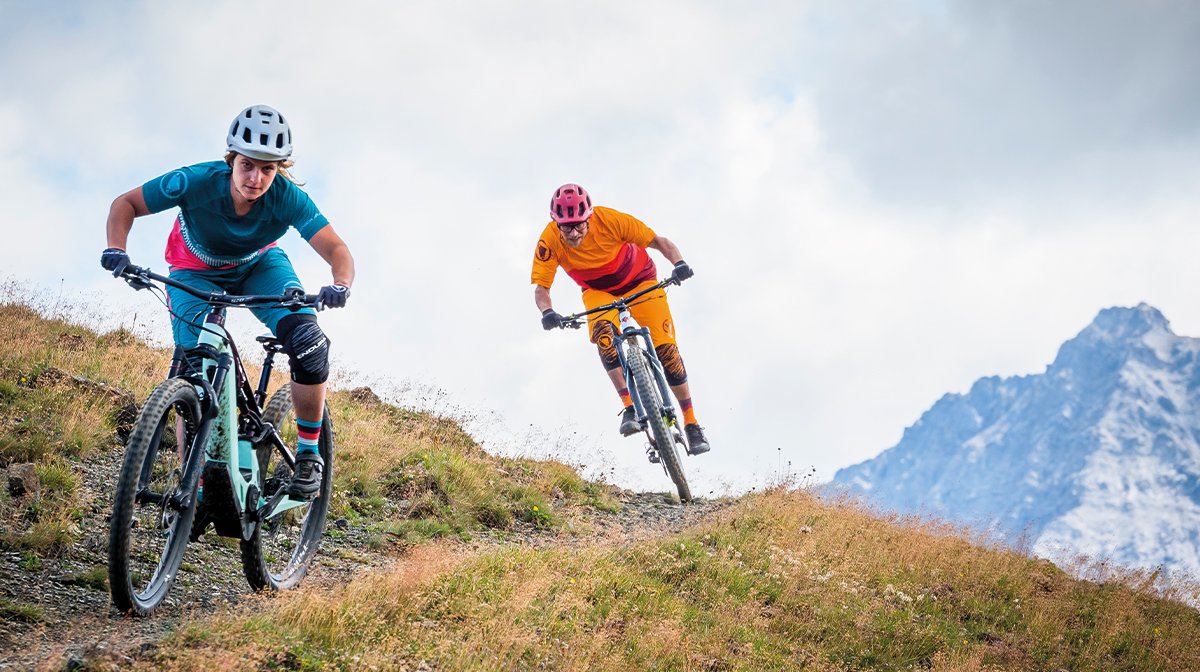 Two mountain bikers speed by