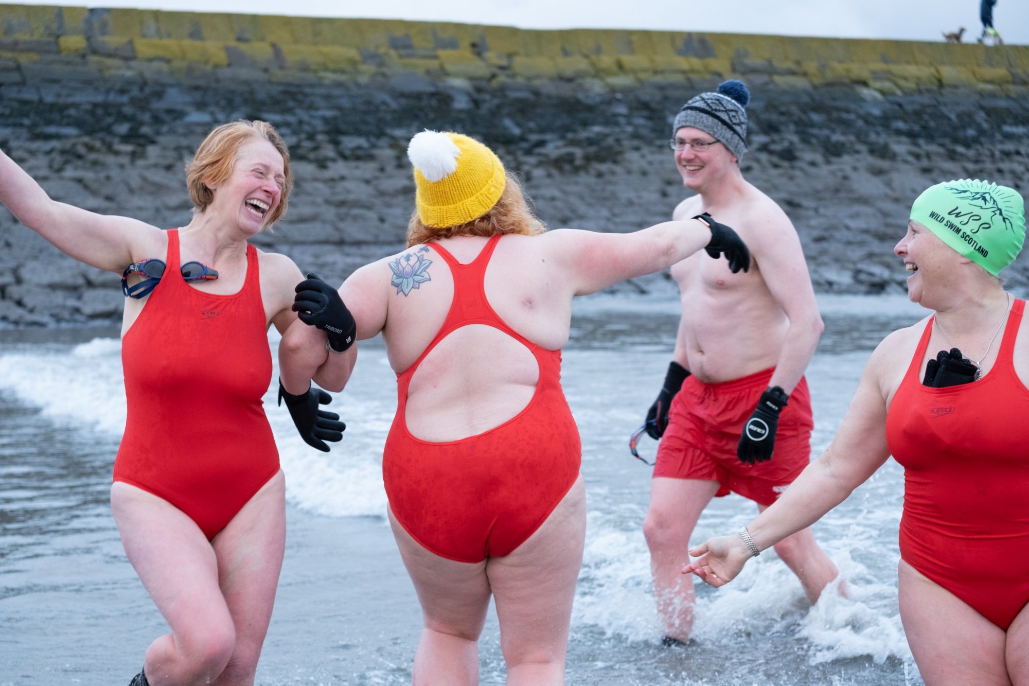 Swimmers dance joyfully in the water