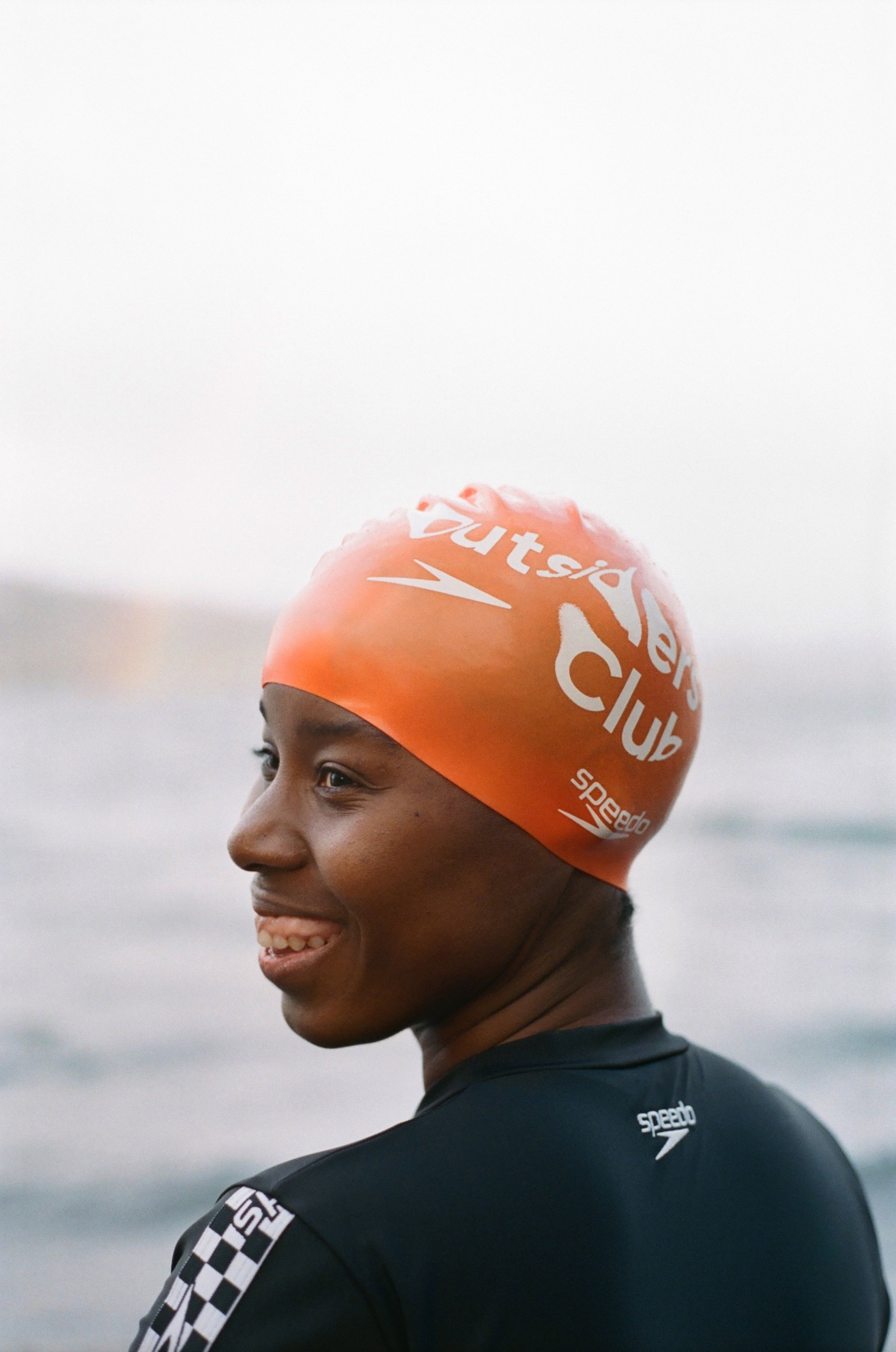 Close up of lady wearing orange speedo cap