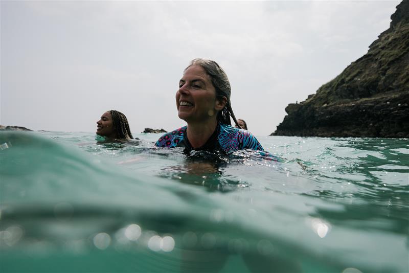 Woman swims in sea in Speedo swimsuit
