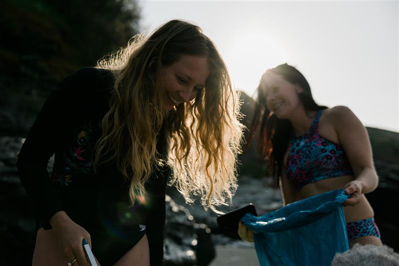 Women smile on beach in Speedo swimwear