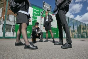 Image of four schoolchildren on a playground wearing Kickers school shoes 