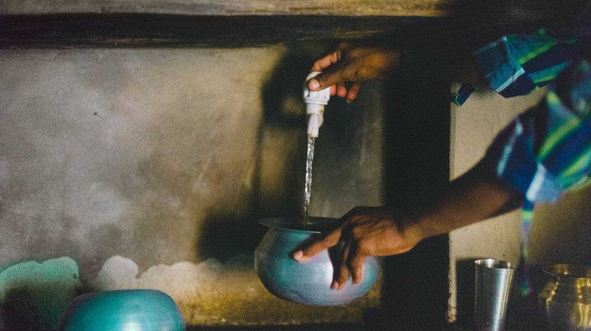 Person cleans bowl in India