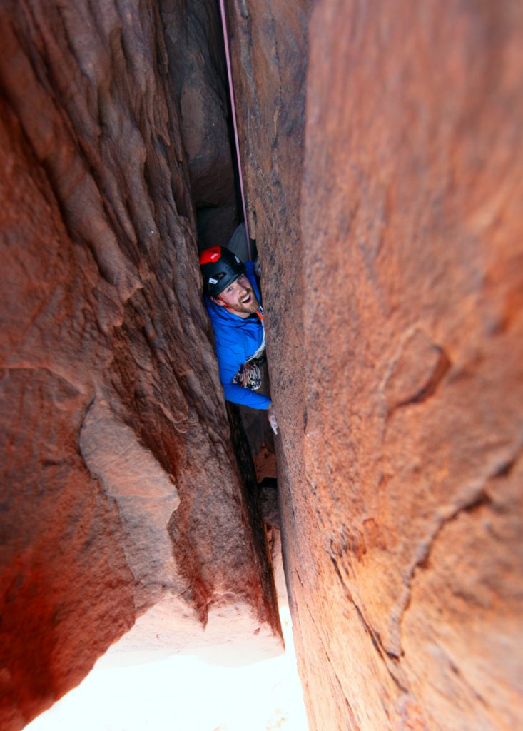 Waldo climbing in tight crack in rock wall