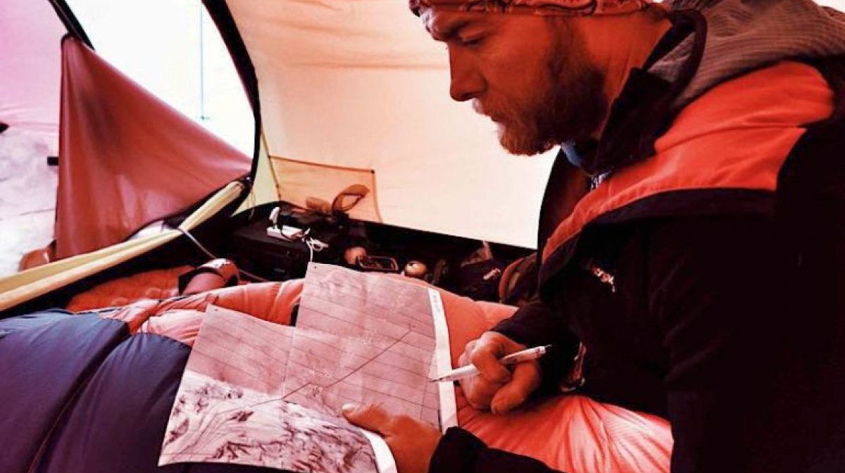 Leo planning the day's route on a map