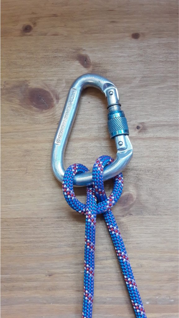 Carabiner and knot from a climbing rope. — Stock Photo