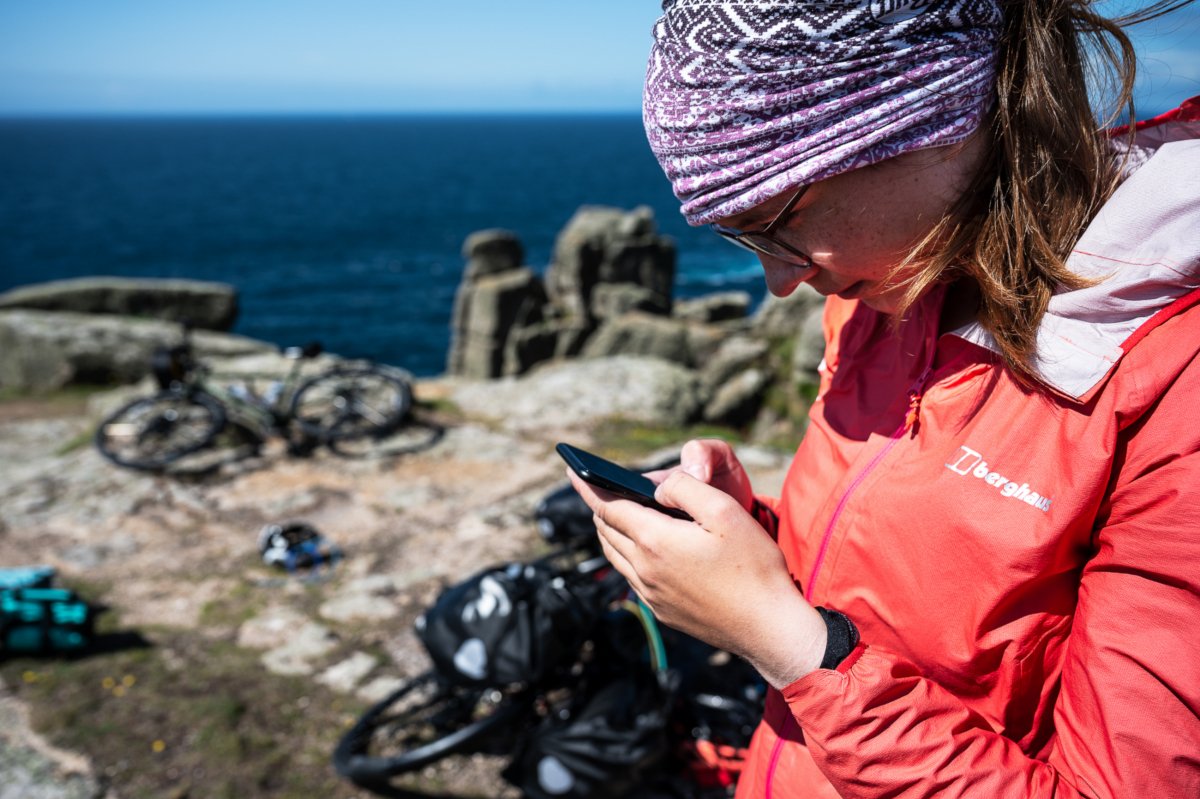 Anna looks at her phone up close