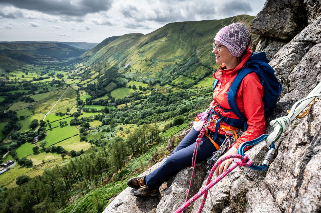 Anna sits on rock with cliff drop