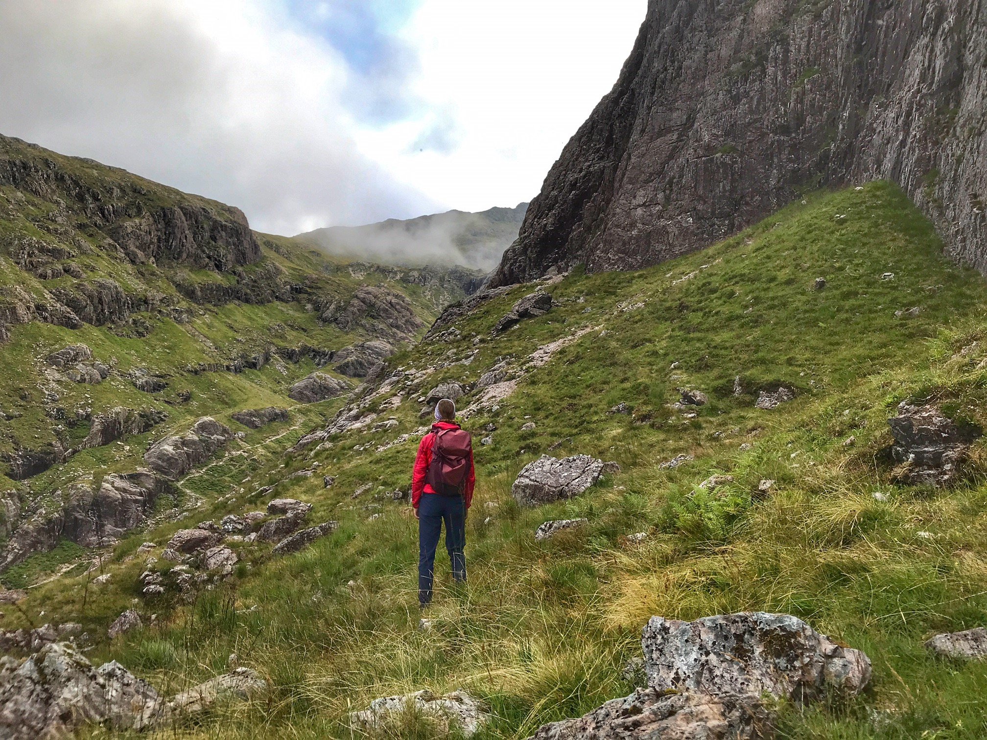 Anna stands in the centre of some hills in Berghaus gear