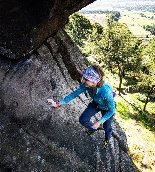 Anna climbing steep rock face