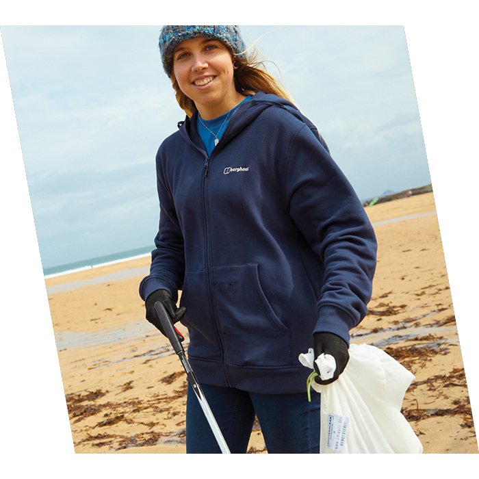 Emily stands up close and smile, while wearing blue Berghaus jumper