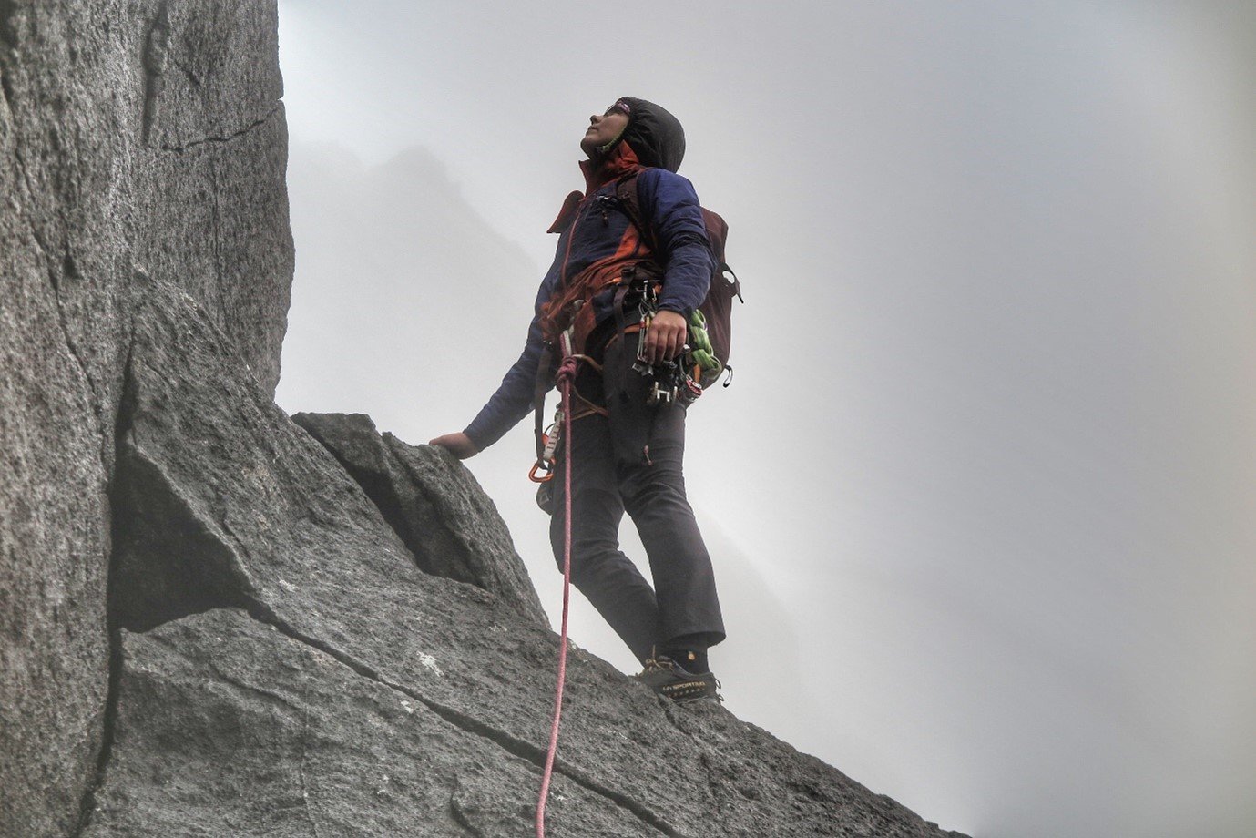 Anna stands atop cliff in Berghaus gear