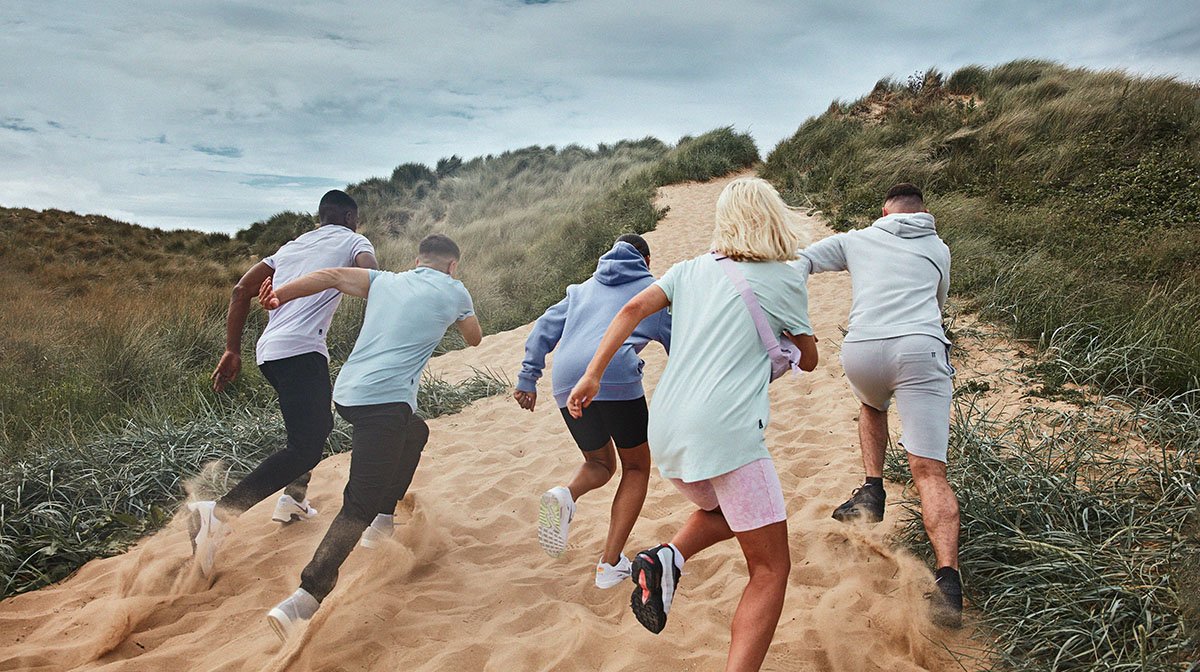 an image of people wearing 11 Degrees clothing on a beach